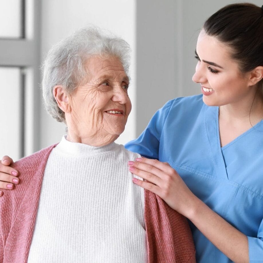 Medical Worker With Senior Woman In Nursing Home