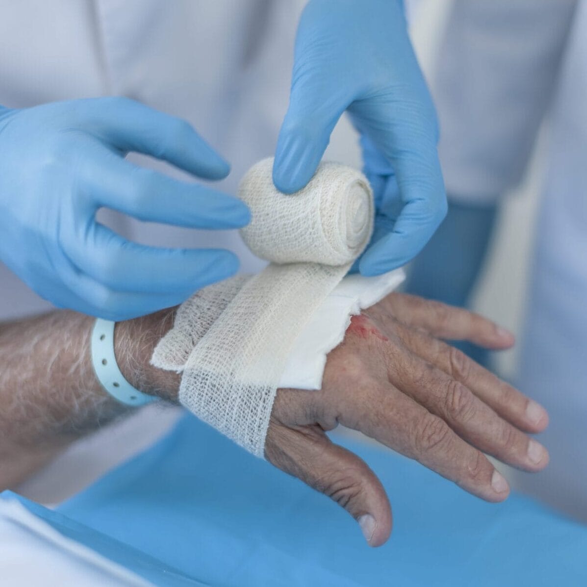 Nurse Dressing A Wound On Patients Hand